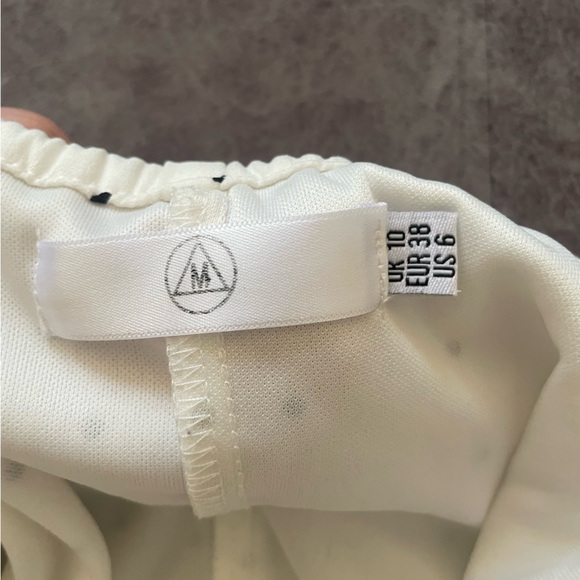 White with black polka dot romper. - Picture 3 of 3